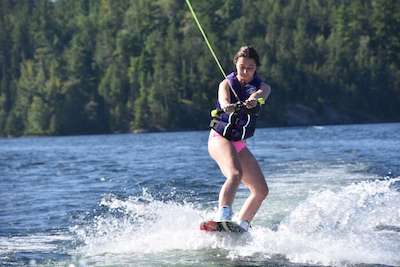 girl wakeboarding at Canadian overnight summer camp